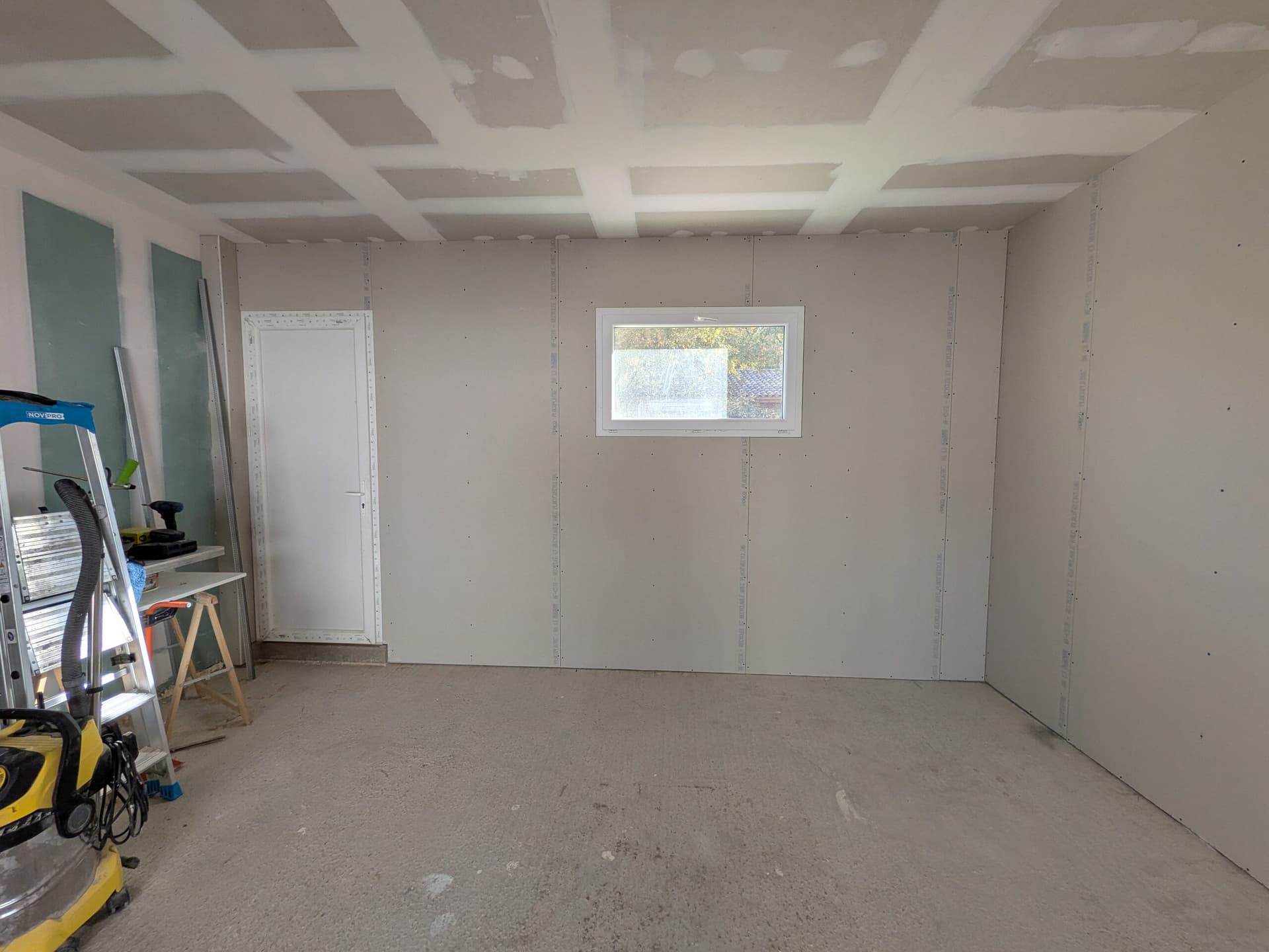 Mur de la fenêtre et de la porte de service plaqué en BA13, doublage presque au nu des menuiseries